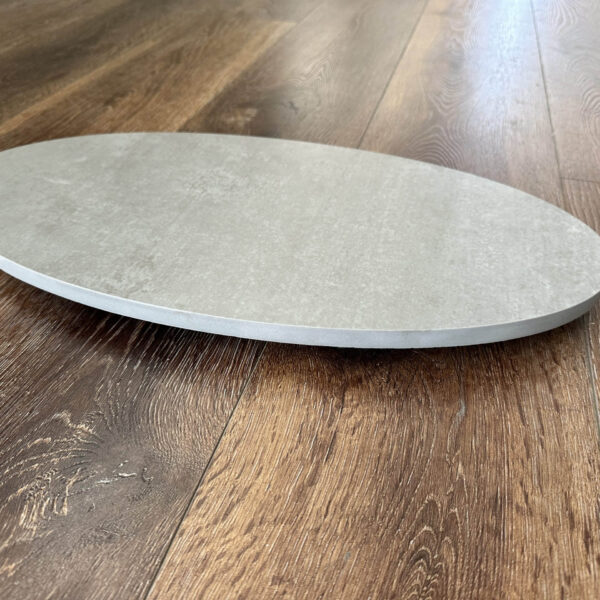Round stone plate on wooden floor.