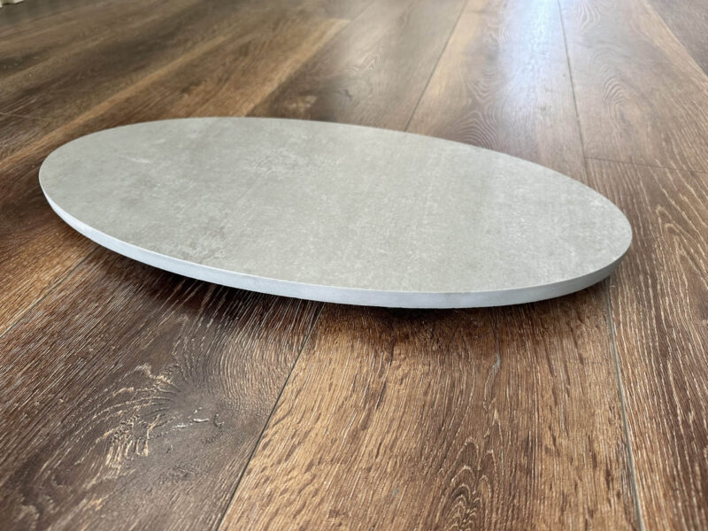 Round stone plate on wooden floor.