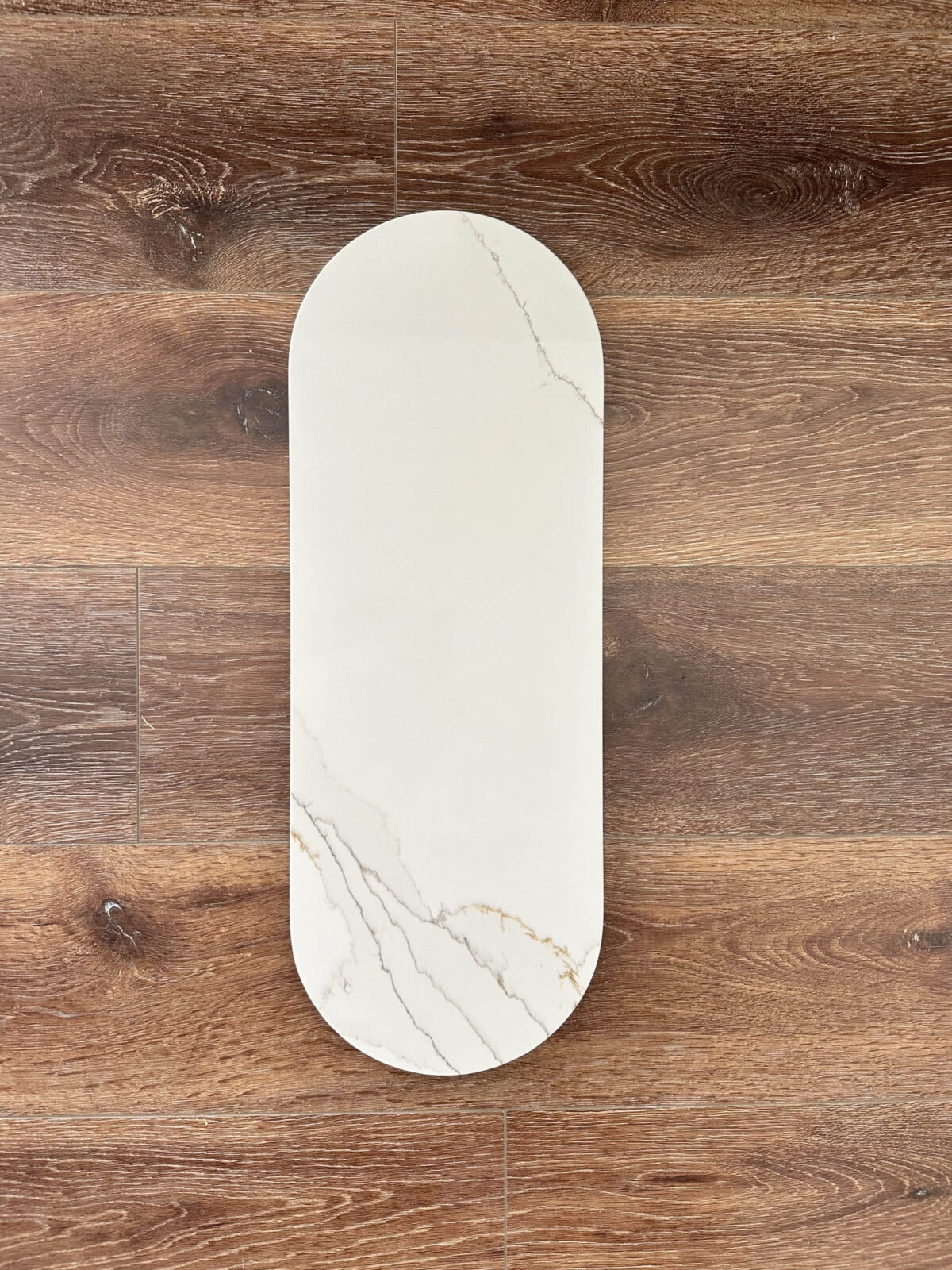 Marble cutting board on wooden floor.