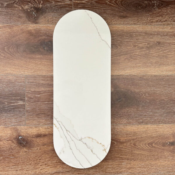 Marble cutting board on wooden floor.