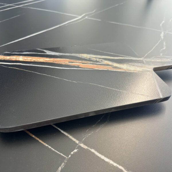 Marble kitchen countertop with a wooden cutting board.