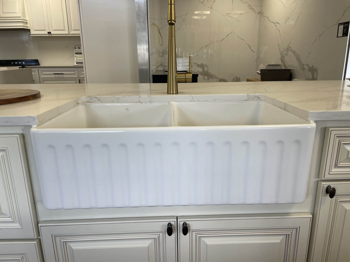 White farmhouse sink in a modern kitchen setting.