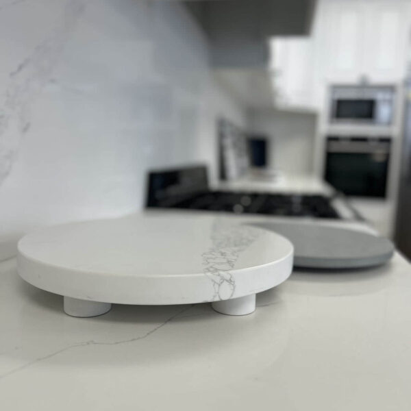 Marble kitchen countertop with round cutting boards in modern kitchen.