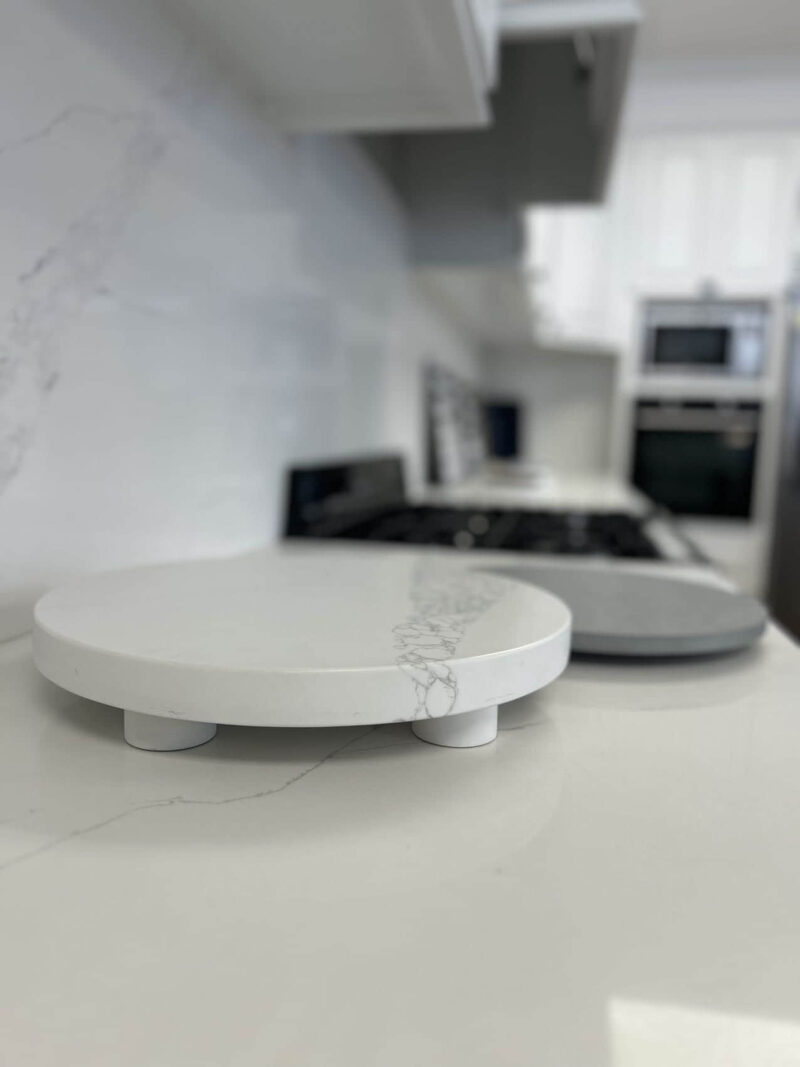 Marble kitchen countertop with round cutting boards in modern kitchen.
