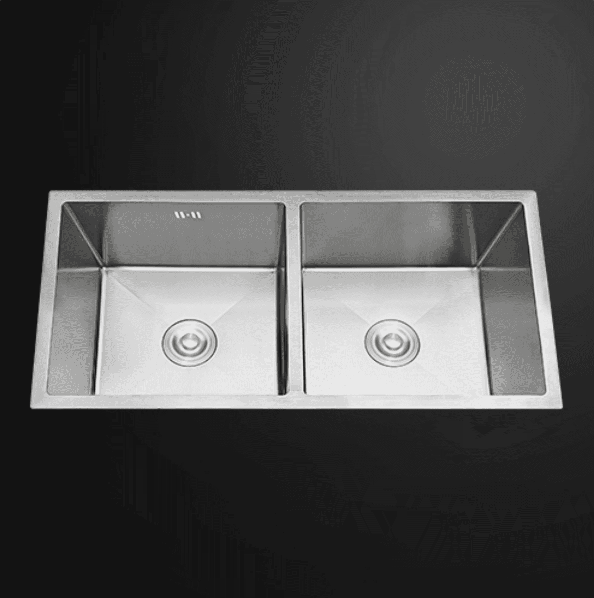 Double bowl stainless steel kitchen sink on dark background.
