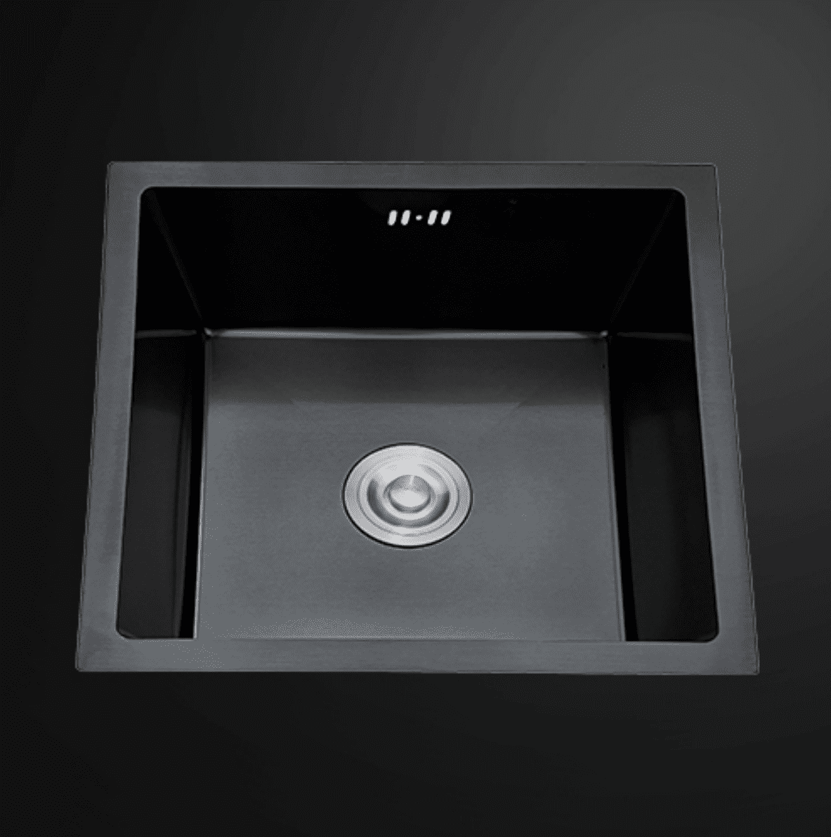 Black square kitchen sink with drain, viewed from above.