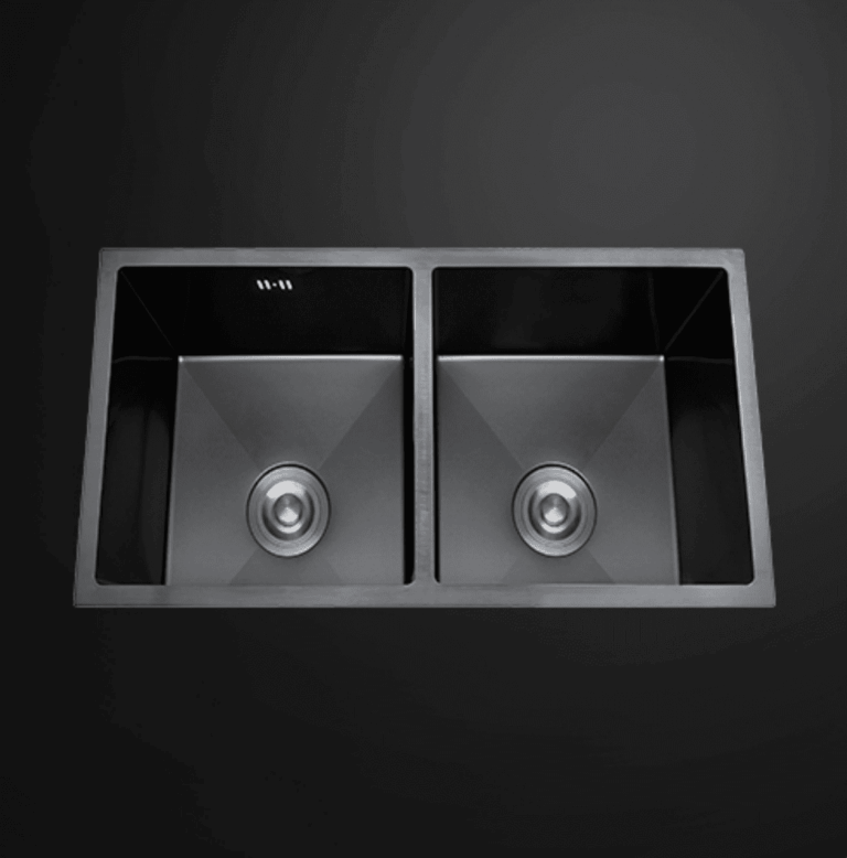 Double bowl black kitchen sink on dark background.
