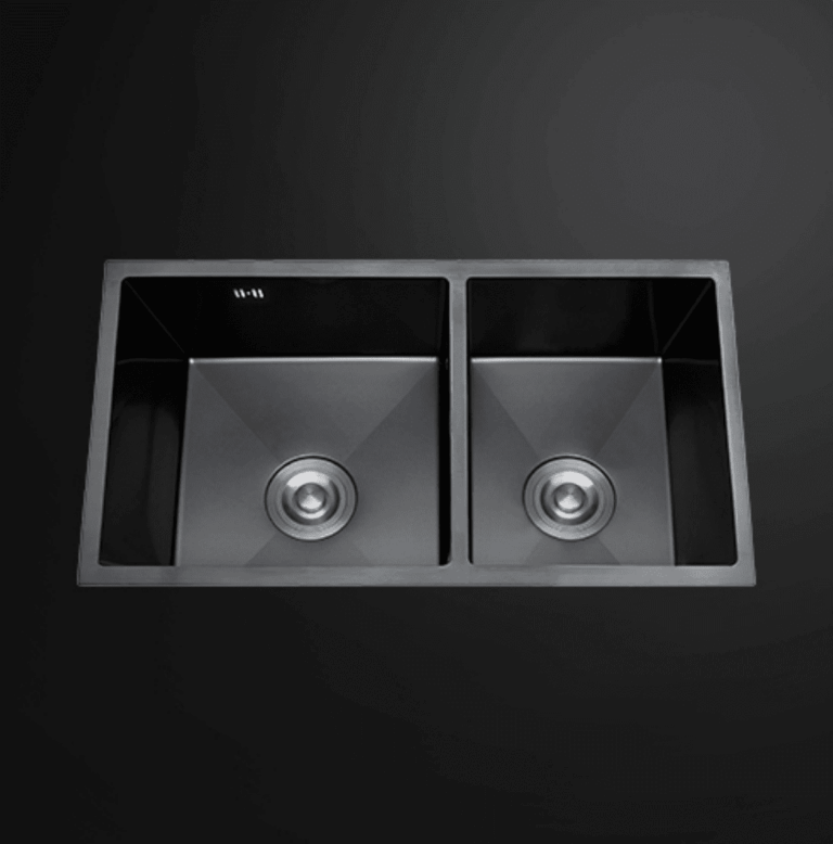 Double bowl black kitchen sink on dark background.