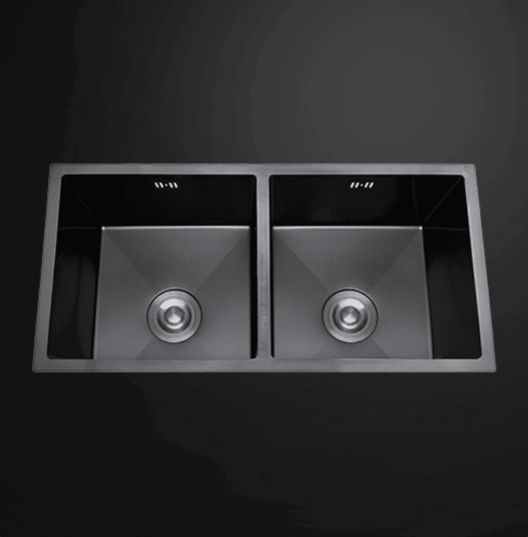 Double bowl black kitchen sink on dark background.