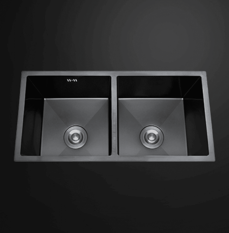Double bowl black kitchen sink on dark background.