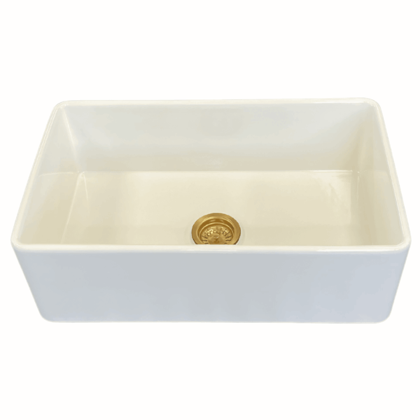 White medium butler sink with gold drain.