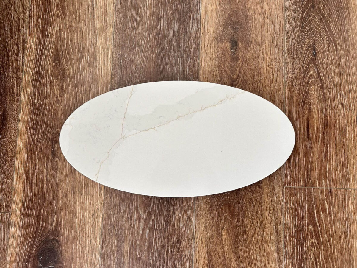 Oval marble plate on wooden floor.