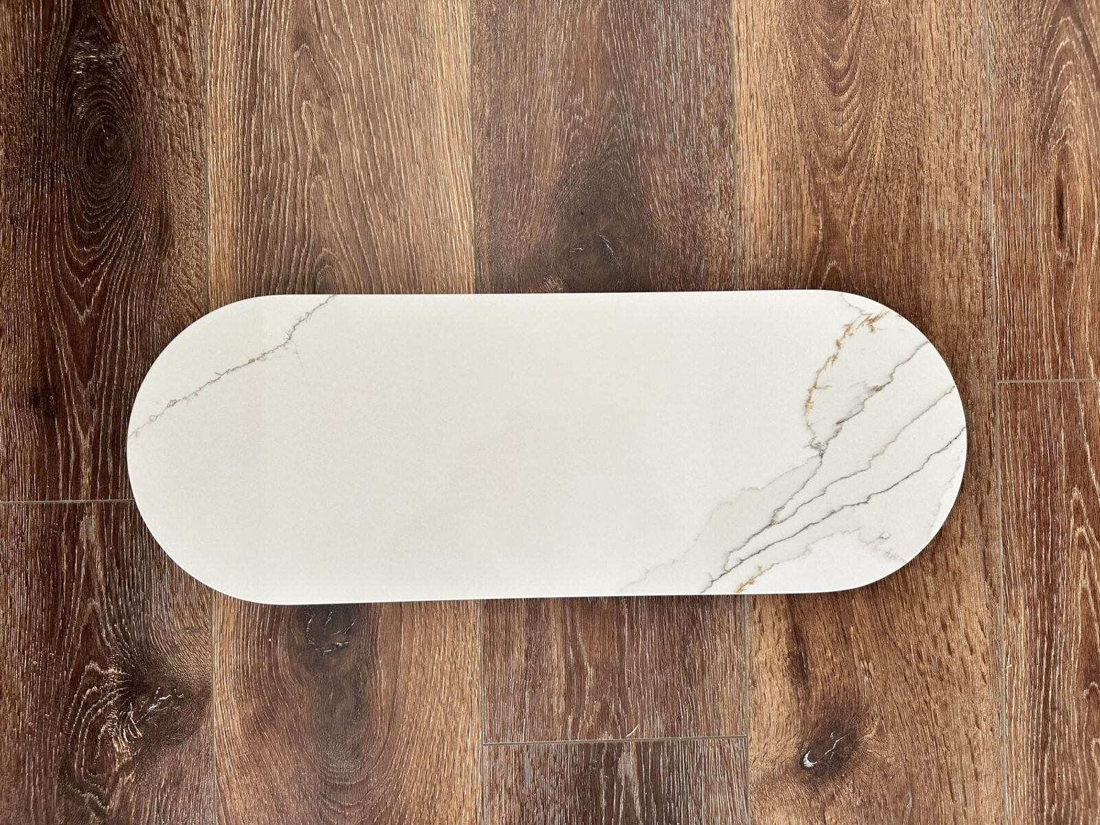 Marble serving platter on wooden floor.