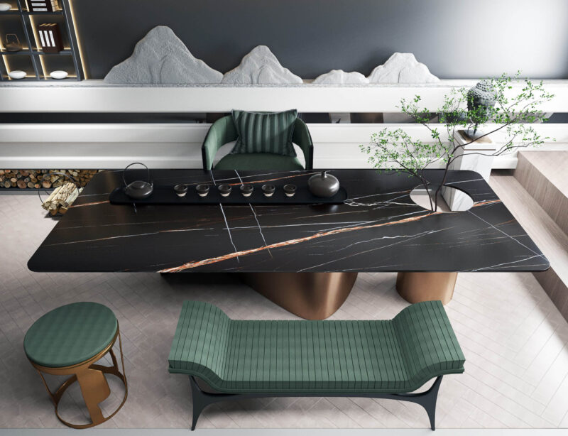 Modern black stone tea table with green seating and decorative elements.