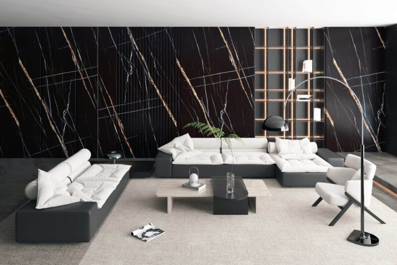 Modern living room with black marble accent wall and contemporary furniture.
