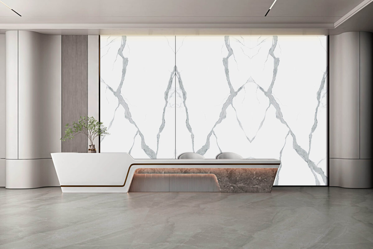 Modern interior with marble-patterned wall and sleek reception desk.