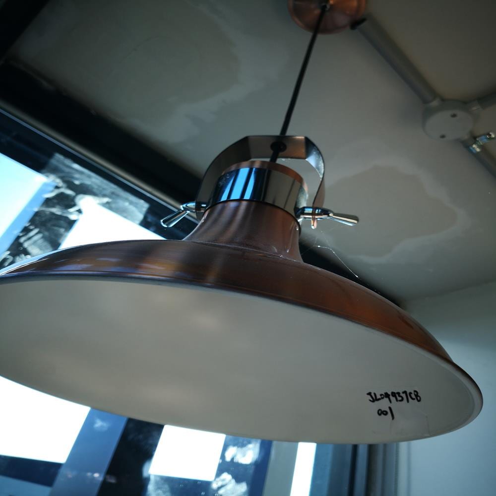 Hanging industrial-style light fixture in a modern kitchen setting.