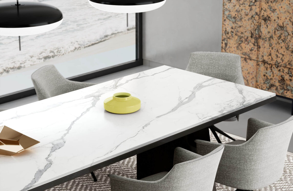 Modern kitchen table with marble surface and yellow vase.
