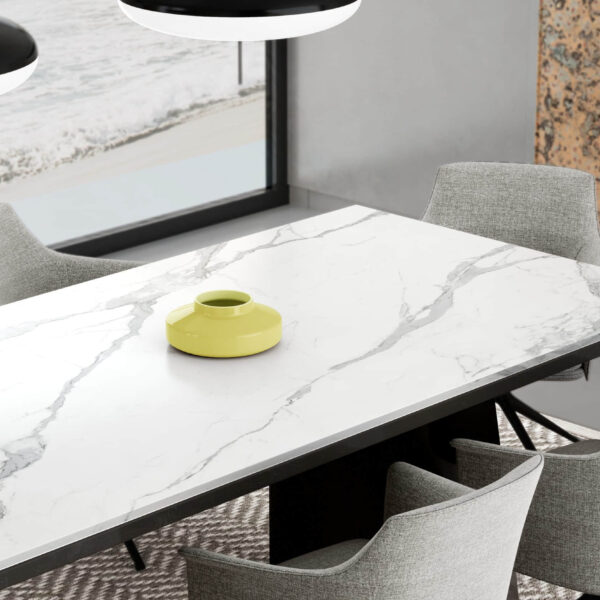 Modern kitchen table with marble surface and yellow vase.