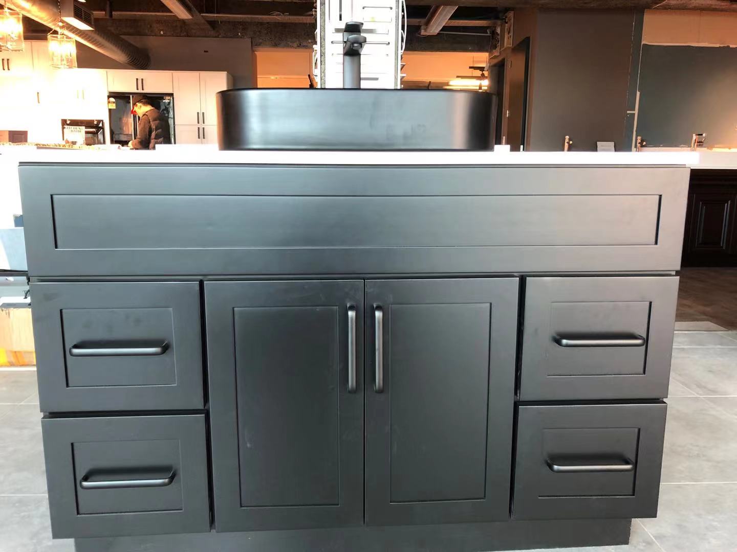 Black kitchen cabinet with modern design and sleek handles.
