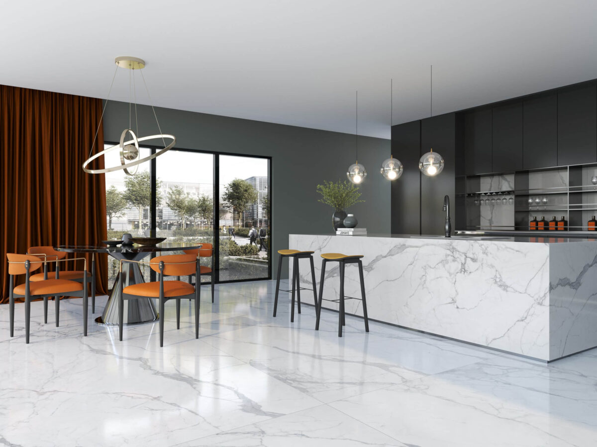 Modern kitchen with marble island, pendant lights, and orange chairs.