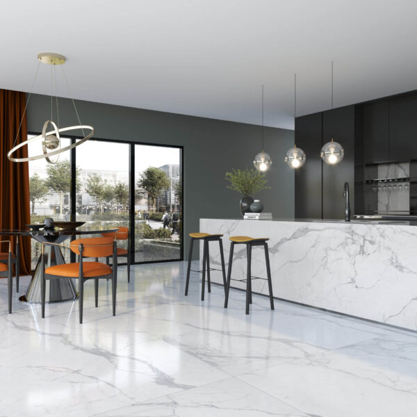 Modern kitchen with marble island, pendant lights, and orange chairs.