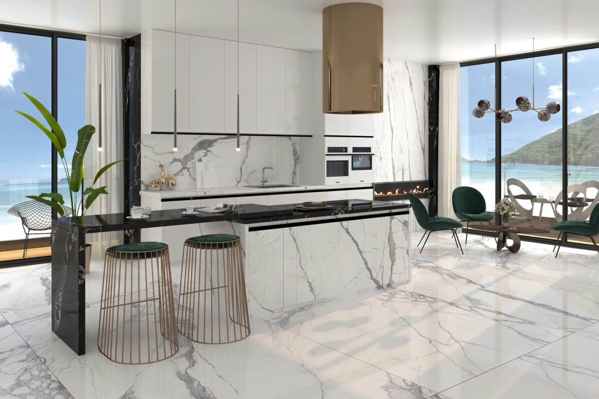 Modern kitchen with marble countertops, island, and green chairs.