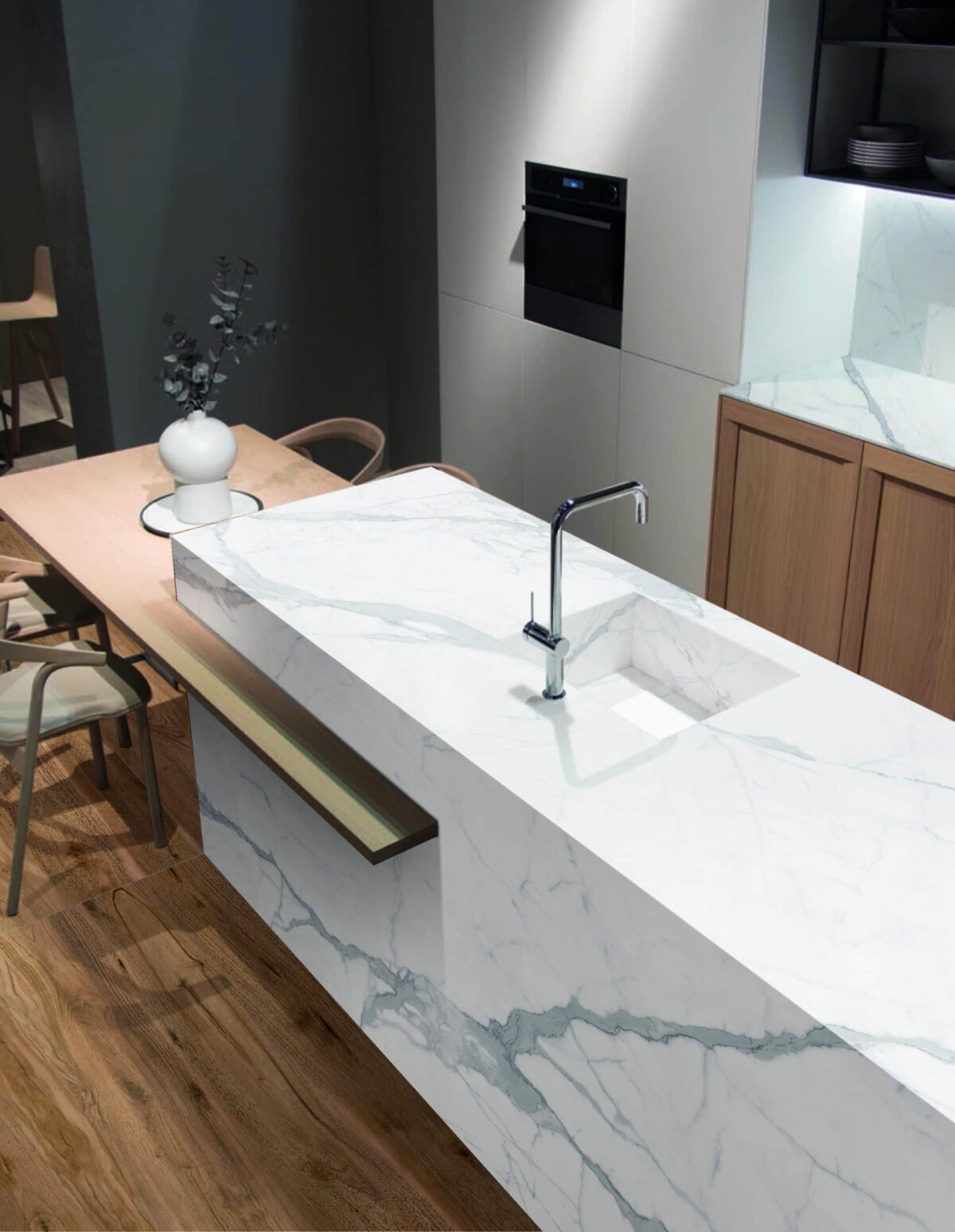 Modern kitchen with marble countertop and integrated sink.