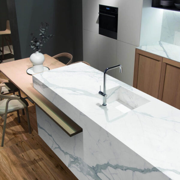 Modern kitchen with marble countertop and integrated sink.