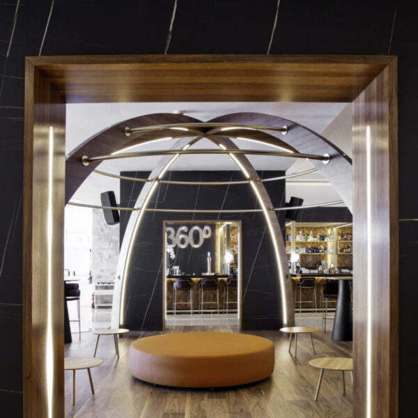 Modern restaurant interior with wooden accents and circular seating.