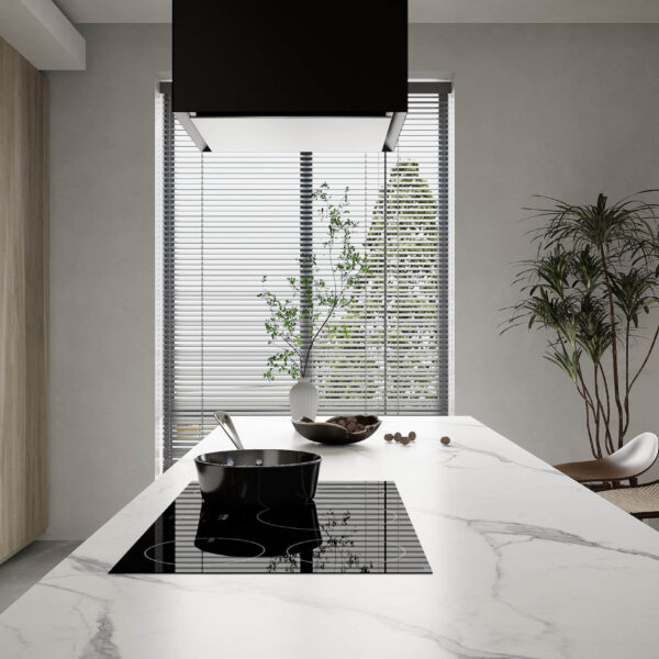 Modern kitchen island with marble countertop and induction cooktop.