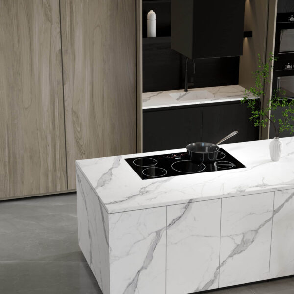 Modern kitchen island with marble countertop and built-in stovetop.
