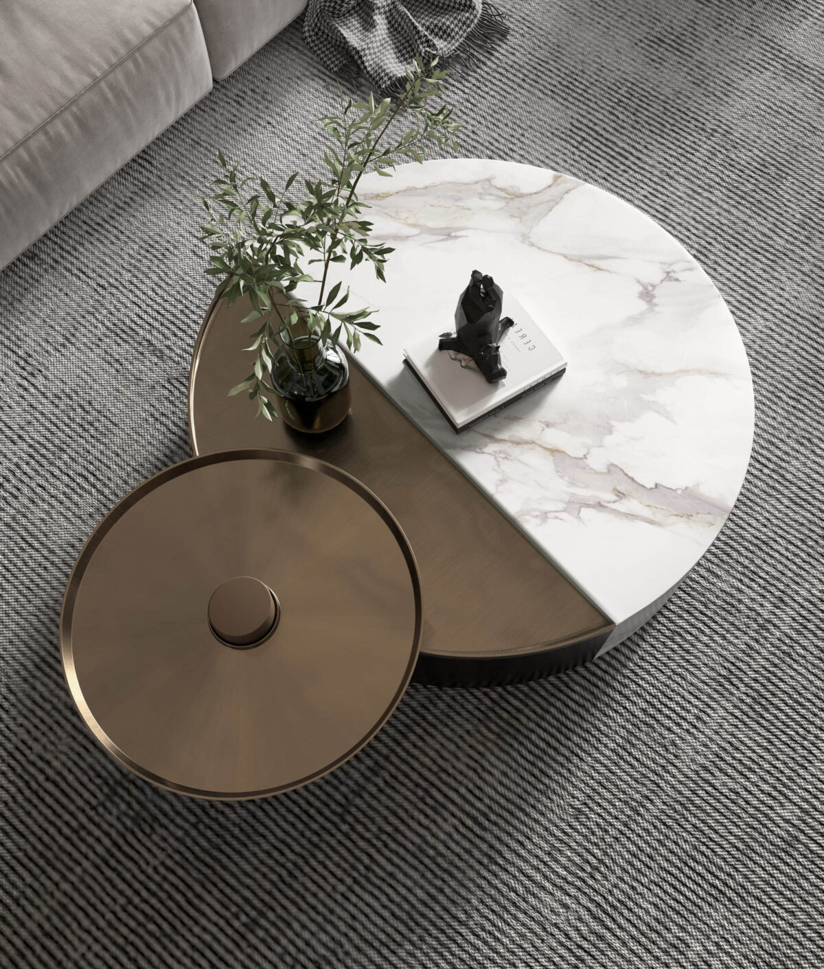 Marble and bronze round coffee table with plant and book.