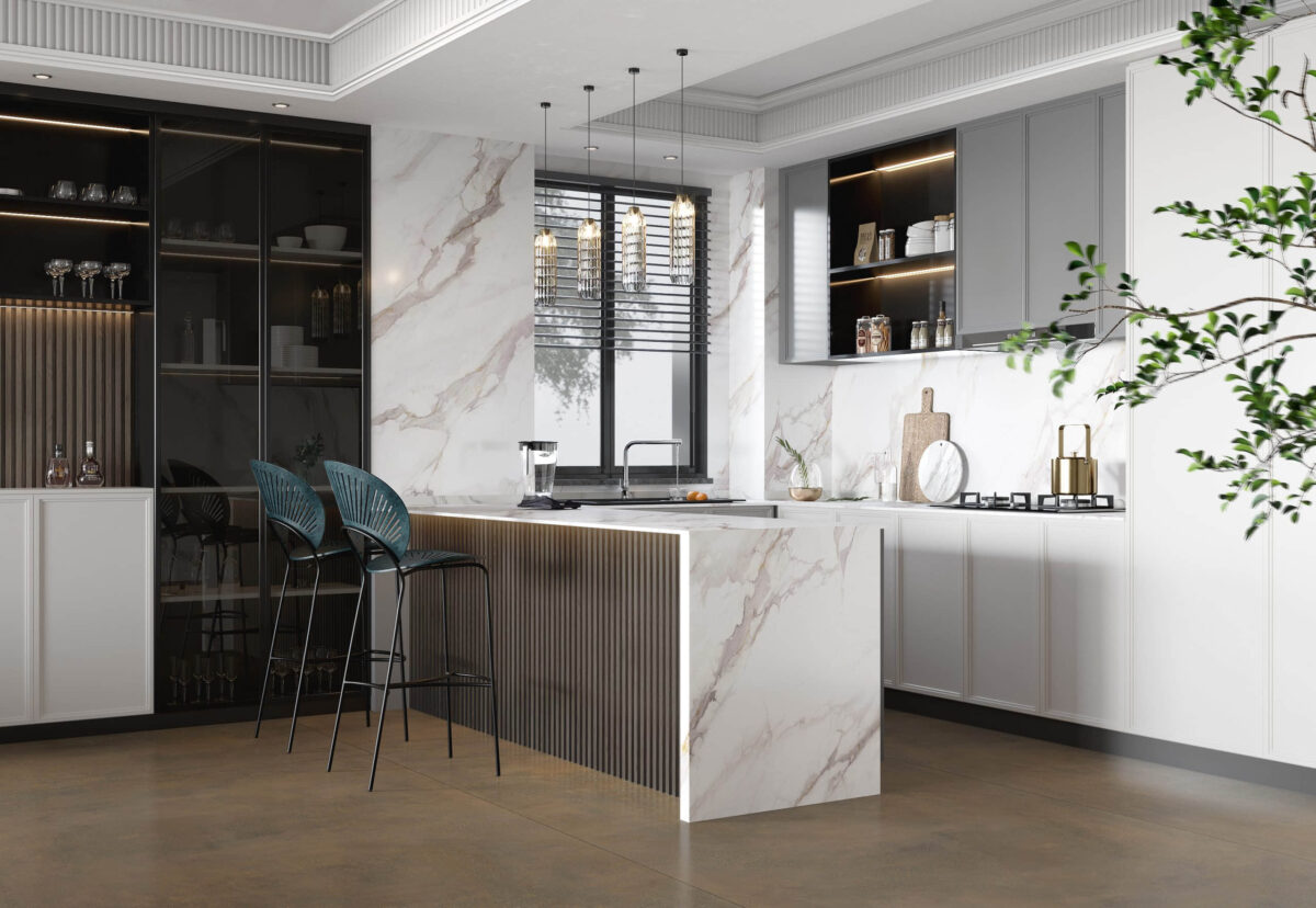 Modern kitchen with marble countertops, bar stools, and elegant lighting.