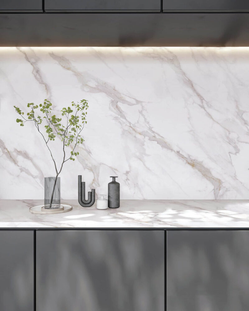 Marble countertop with vase and decorative items.